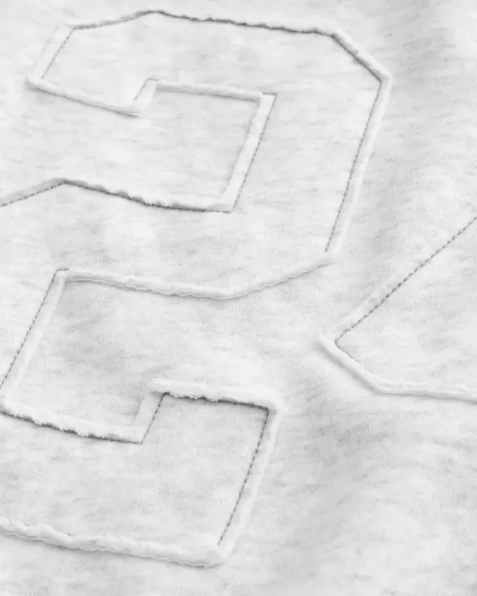 Felpa con stampa grafica e numero a spalle scoperte
