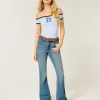 Jeans a zampa a vita alta con lavaggio medio