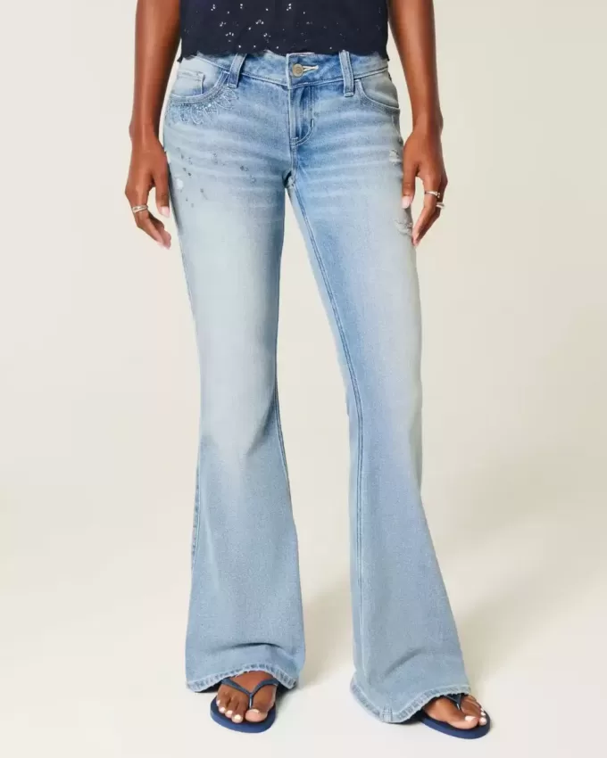 Jeans a zampa con paillettes lavaggio chiaro e vita ultra bassa effetto consumato