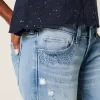 Jeans a zampa con paillettes lavaggio chiaro e vita ultra bassa effetto consumato