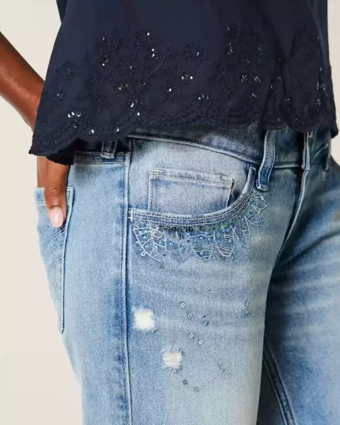 Jeans a zampa con paillettes lavaggio chiaro e vita ultra bassa effetto consumato