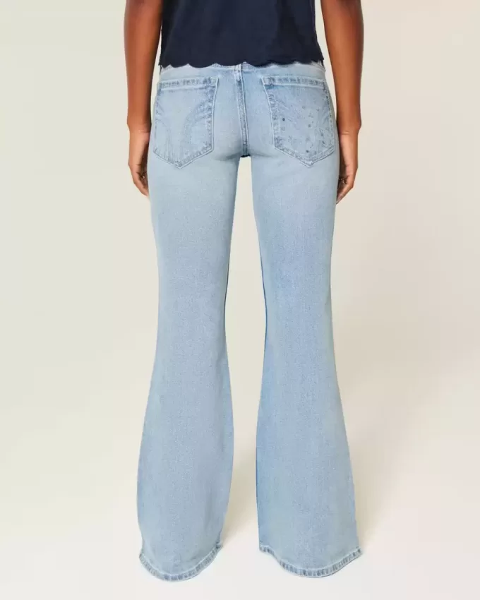 Jeans a zampa con paillettes lavaggio chiaro e vita ultra bassa effetto consumato