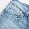 Jeans a zampa con paillettes lavaggio chiaro e vita ultra bassa effetto consumato