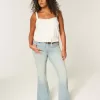 Jeans a zampa con tasche a stella e lavaggio chiaro a vita alta