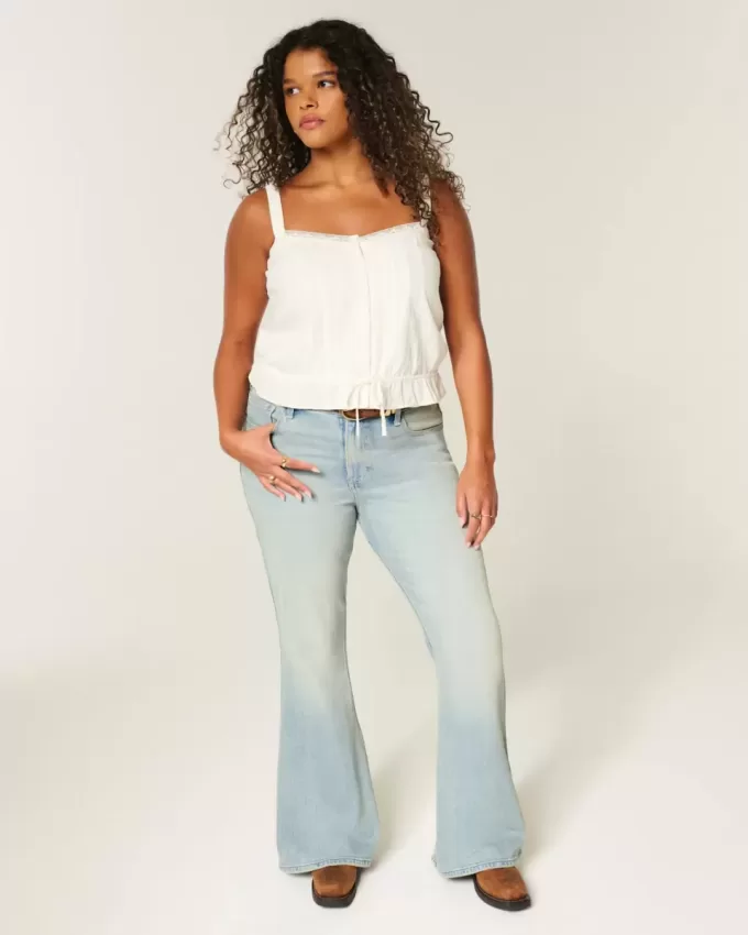 Jeans a zampa con tasche a stella e lavaggio chiaro a vita alta