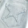 Jeans a zampa con tasche a stella e lavaggio chiaro a vita alta