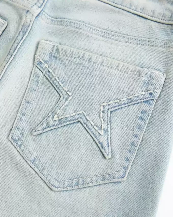 Jeans a zampa con tasche a stella e lavaggio chiaro a vita alta