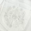 Jeans a zampa con tasche ricamate bianche a vita bassissima