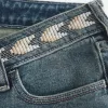 Jeans a zampa ricamati a lavaggio medio e vita bassissima