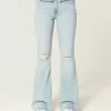 Jeans a zampa strappati a vita alta e lavaggio chiaro