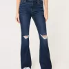 Jeans a zampa strappati a vita alta e lavaggio scuro
