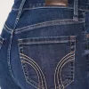 Jeans a zampa strappati a vita alta e lavaggio scuro