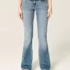 Jeans bootcut a vita bassa con lavaggio medio effetto consumato