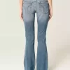 Jeans bootcut a vita bassa con lavaggio medio effetto consumato