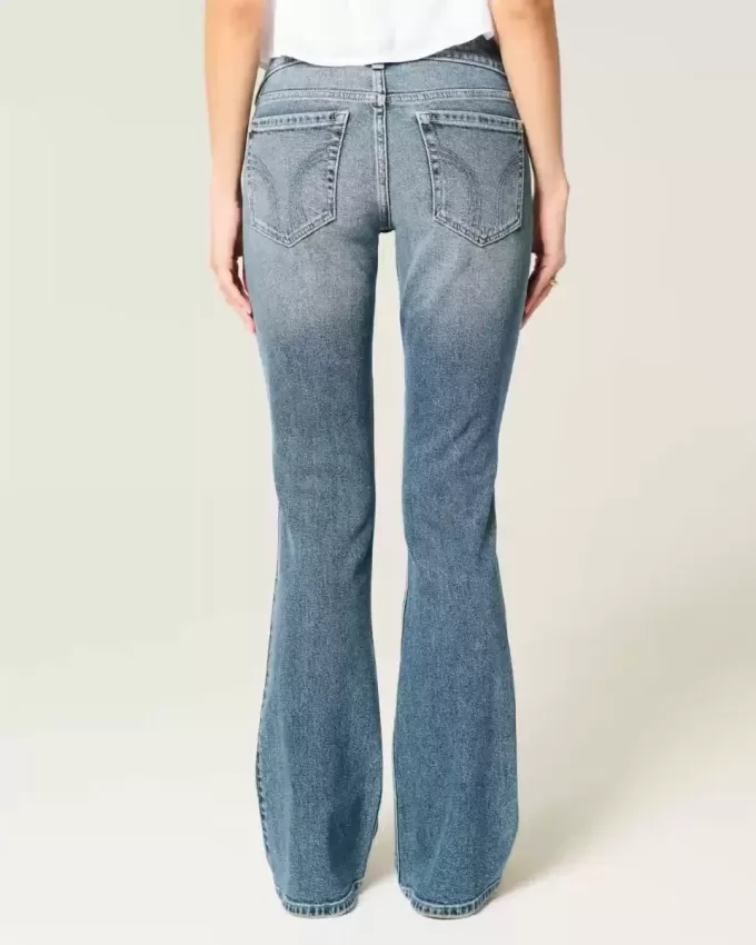 Jeans bootcut a vita bassa con lavaggio medio effetto consumato