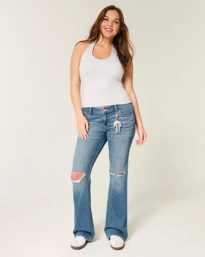 Jeans bootcut a vita bassa con strappi e lavaggio medio