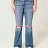 Jeans bootcut a vita bassa con strappi e lavaggio medio