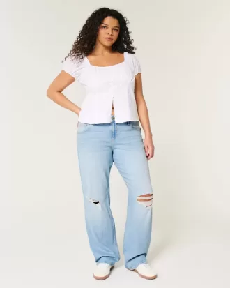 Jeans dritti e rilassati con lavaggio chiaro e strappi a vita bassa