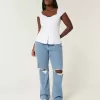Jeans dritti e rilassati con lavaggio medio e vita bassa e strappi curvy