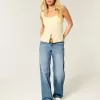 Jeans larghi a vita bassa con cuori borchiati e lavaggio medio