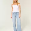 Jeans larghi a vita bassa con fiocchi borchiati e lavaggio chiaro
