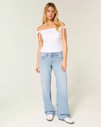 Jeans larghi a vita bassa con fiocchi borchiati e lavaggio chiaro
