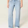 Jeans larghi a vita bassa con fiocchi borchiati e lavaggio chiaro