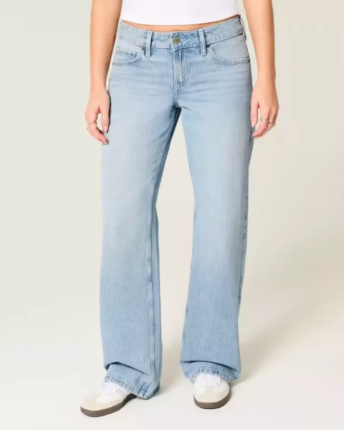 Jeans larghi a vita bassa con fiocchi borchiati e lavaggio chiaro