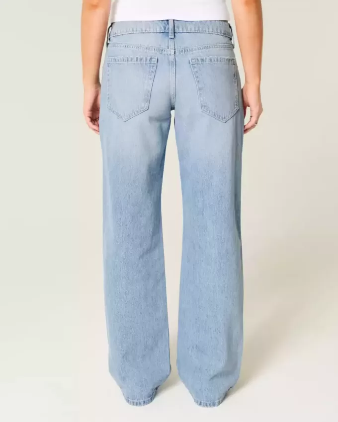 Jeans larghi a vita bassa con fiocchi borchiati e lavaggio chiaro