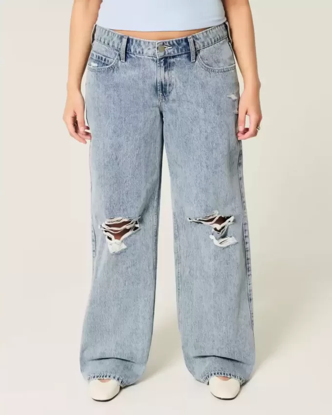 Jeans larghi a vita bassa con lavaggio medio e strappi