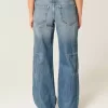 Jeans larghi a vita bassa con stampa a stelle e lavaggio medio