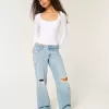 Jeans larghi a vita bassa con strappi e lavaggio chiaro