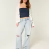 Jeans larghi a vita bassa con strappi e lavaggio chiaro