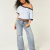 Jeans larghi a vita bassa con strappi e lavaggio chiaro