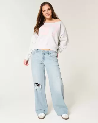 Jeans larghi a vita bassa con strappi e lavaggio chiaro