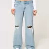 Jeans larghi a vita bassa con strappi e lavaggio chiaro