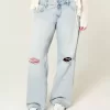 Jeans larghi a vita bassa con strappi e lavaggio chiaro