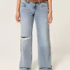 Jeans larghi a vita bassa con strappi e lavaggio chiaro