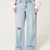 Jeans larghi a vita bassa con strappi e lavaggio chiaro