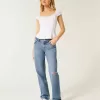 Jeans larghi a vita bassa con strappi e lavaggio medio