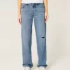 Jeans larghi a vita bassa con strappi e lavaggio medio