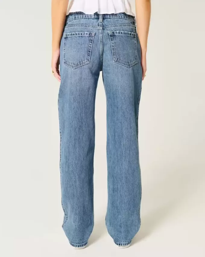 Jeans larghi a vita bassa con strappi e lavaggio medio