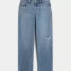 Jeans larghi a vita bassa con strappi e lavaggio medio