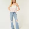 Jeans larghi a vita bassa e lavaggio chiaro strappati