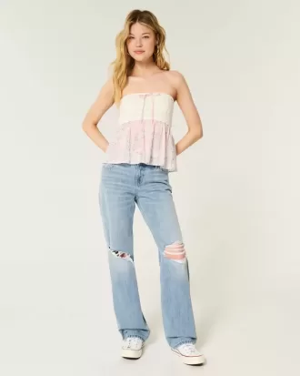 Jeans larghi a vita bassa e lavaggio chiaro strappati
