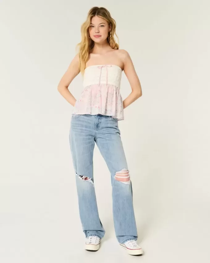 Jeans larghi a vita bassa e lavaggio chiaro strappati