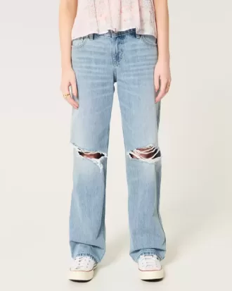 Jeans larghi a vita bassa e lavaggio chiaro strappati