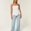 Jeans larghi a vita bassa e lavaggio medio con effetto curvy