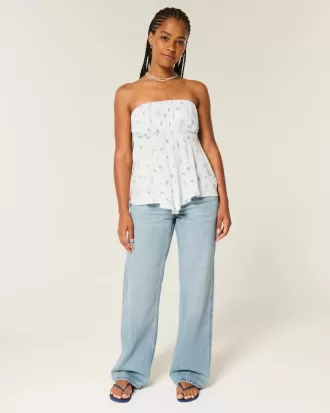 Jeans larghi a vita bassa e lavaggio medio con effetto curvy