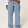 Jeans larghi a vita bassa e lavaggio medio con effetto curvy